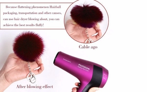Macro detail showing how to fluff a burgundy faux rabbit fur keychain with a hair dryer