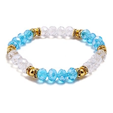 Detailed macro view of beaded bracelet with sky blue faceted beads and gold accents