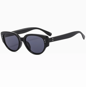 Detailed view of cat eye sunglasses with black thick frames and silver metal rivets