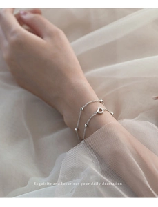 Detail of S925 sterling silver double-layer bracelet with D-shaped pendant and beads
