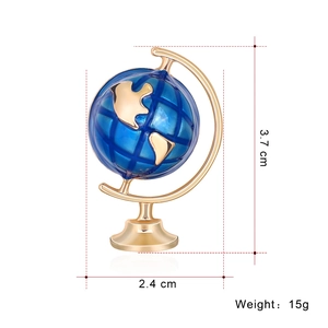 Globe enamel brooch in gold and blue finish with dimensions 3.7cm x 2.4cm