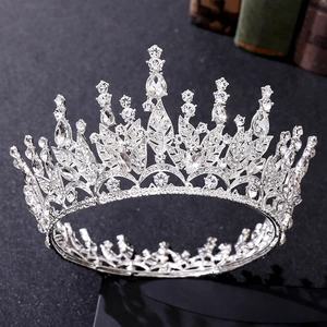 Macro view of silver leaf crown with red crystals and rhinestones on black background