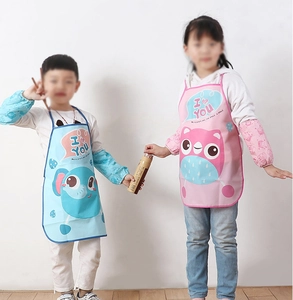 Detail of waterproof cartoon kids aprons in blue elephant and pink owl patterns