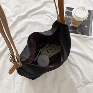 Large capacity black nylon tote bag with leather straps on aesthetic lifestyle background