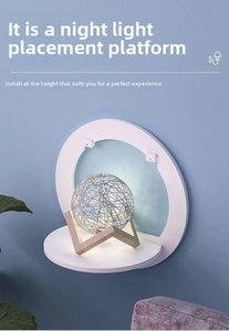 Detail view of the round white wall shelf used as a small bedside nightstand platform