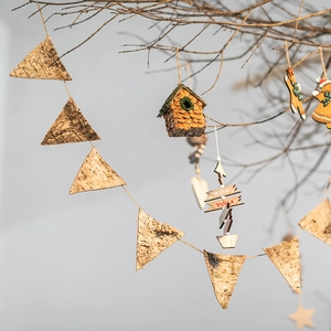 Handcrafted birch bark triangle banners with small wooden birdhouses for Christmas decor