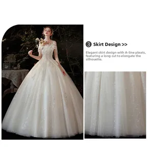 Détail d'une robe de mariée blanche ligne A avec paillettes argentées et bordure en dentelle