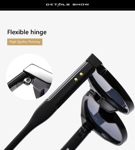Detail of flexible hinges and golden star accents on glossy black oversized sunglasses