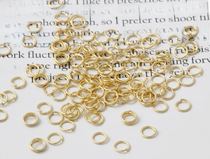 Close-up of shiny 18K gold plated jump rings for DIY jewelry making and handmade accessories