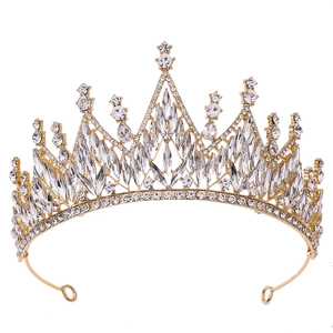 Close-up of sparkling white crystals and gold baroque bridal crown with detailed rhinestones