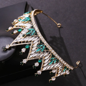 Baroque princess crown with green and white crystals on a gold metal frame