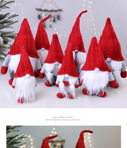 Close-up of plush Christmas Gnomes with red knitted hats and grey heart embroidery