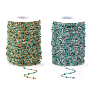 Detail of gold and silver beaded chains with lake blue enamel beads for DIY jewelry