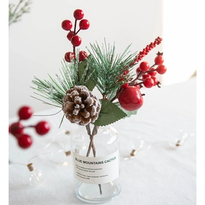 Artificial Christmas berry picks with pine cones and needles in a warm home setting