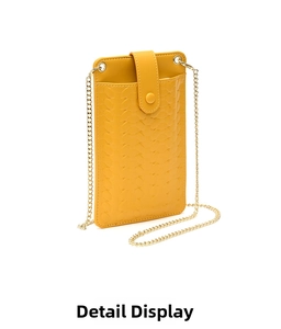 Detail of yellow woven phone crossbody bag with gold chain and snap closure