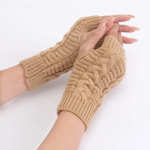Detail of cable knit fingerless gloves in camel showing the thick texture and ribbed cuff