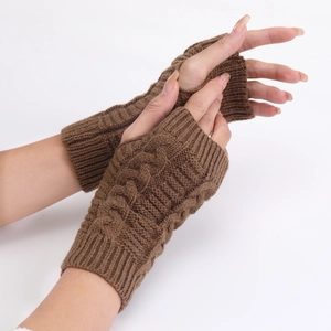 Detailed close-up of brown cable knit pattern on fingerless warm winter wrist gloves