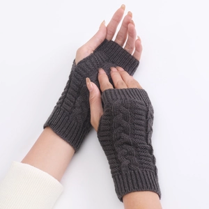 Close-up of dark grey cable-knit fingerless gloves showing detailed wool texture