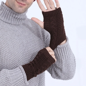 Detail of dark coffee cable knit fingerless gloves showing thick texture and weave pattern
