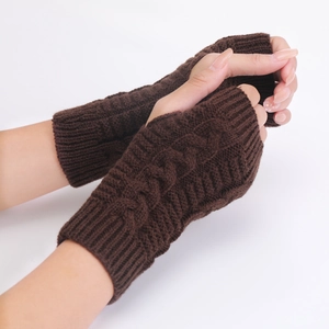 Close-up of dark brown cable knit fingerless gloves with ribbed cuffs on white background