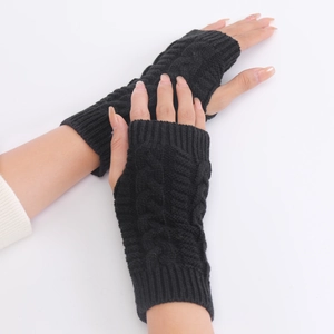 Close-up of black cable knit fingerless gloves showing warm textured wool wrist warmers