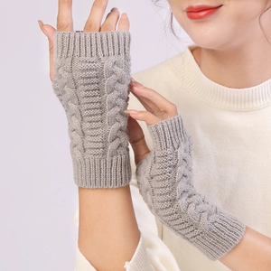 Detail of grey cable knit fingerless gloves showing soft yarn texture and ribbed cuff
