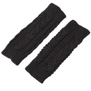 Detail of cable knit black fingerless gloves showing thick wool texture and elastic cuffs