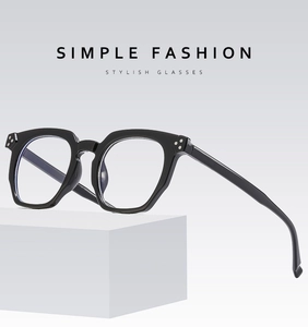 Detail of black retro glasses with silver dots decoration on a white block