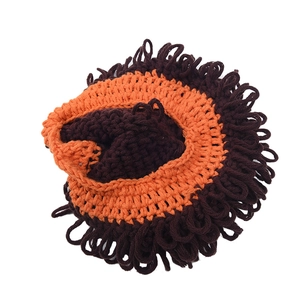 Handmade crochet lion mane baby hat with brown and orange yarn for winter warmth