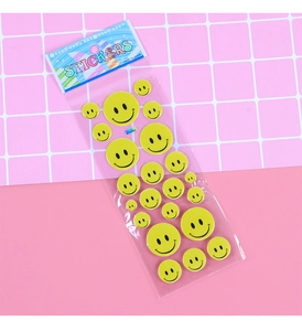 Close-up of assorted yellow smiley face puff stickers in retail hanging packaging