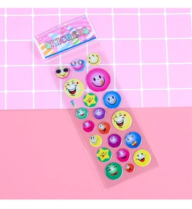 Macro detail of colorful 3D emoji bubble stickers in clear packaging on pink grid background