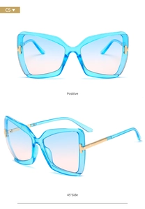 Detail of butterfly frame sunglasses with blue gradient lenses and golden T-hinge