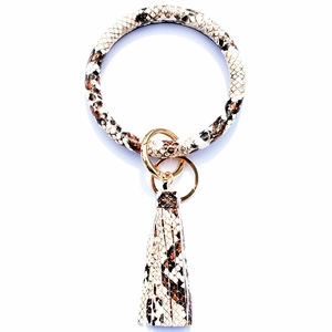 Detail view of snakeskin pattern leather keychain bracelet with golden clasp and long tassel