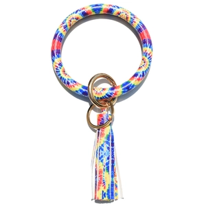 Detail of colorful tie-dye leather keychain with large bangle ring and golden tassel