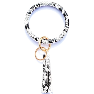 Detail of snake skin print leather keyring bracelet with golden ring and long fringe tassel