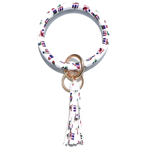 Detail of white cactus print leather bangle keychain with golden ring and tassel fringe