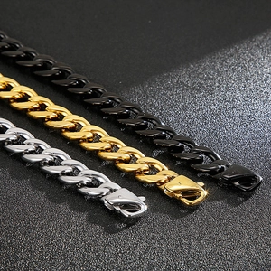 Three Cuban link chains in black, gold, and silver finishes with lobster clasps