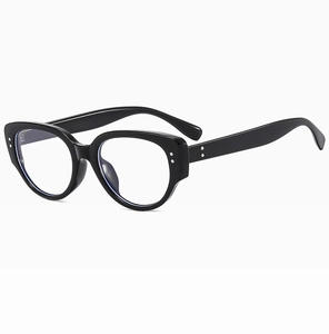 Detail of black cat-eye sunglasses with silver rivets and clear lenses at 45-degree angle