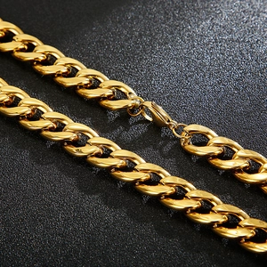 Macro detail of thick golden 304 stainless steel Cuban chain on black background
