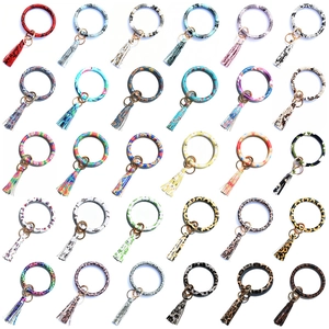 Collection of faux leather O-ring wristlet keychains in snake and leopard patterns