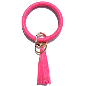 Detail of rose red lychee leather ring keychain with matching tassel and gold hardware