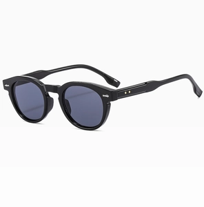 Detail of black retro round sunglasses with silver wing accents and keyhole bridge design