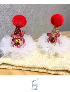 Detail of glitter Christmas hat hair clips with festive bells and red plush pom poms