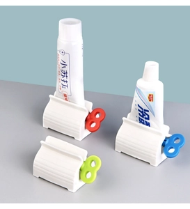 Detail of manual rolling toothpaste squeezer with colorful knobs for tubes