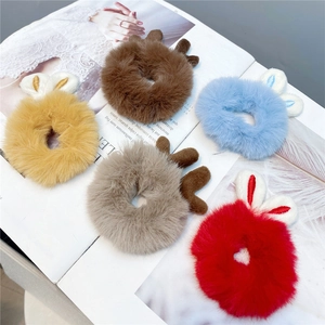 Close-up of colorful plush reindeer antler hair scrunchies on a fashion magazine