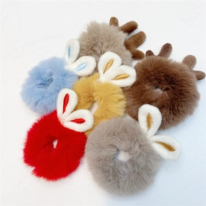 Close-up of soft plush bunny ear hair ties in various colors with embroidered details