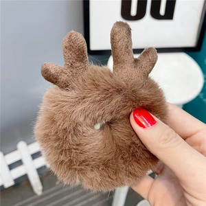 Detail of plush brown reindeer antler hair scrunchie made of soft high-quality faux fur