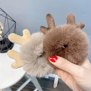 Cute plush reindeer antler hair scrunchie in brown and beige colors for winter hair styling