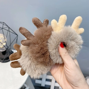 Close-up of plush reindeer antler hair scrunchies in dark brown and light beige colors