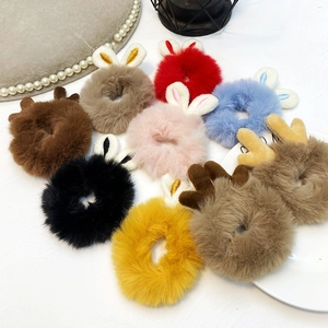 Flat lay of colorful plush hair ties with cute bunny ears and reindeer antlers design